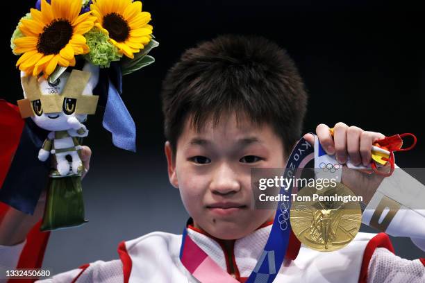 Gold medalist Hongchan Quan of Team China celebrates during the medal ceremony for the Women's 10m Platform Final on day thirteen of the Tokyo 2020...