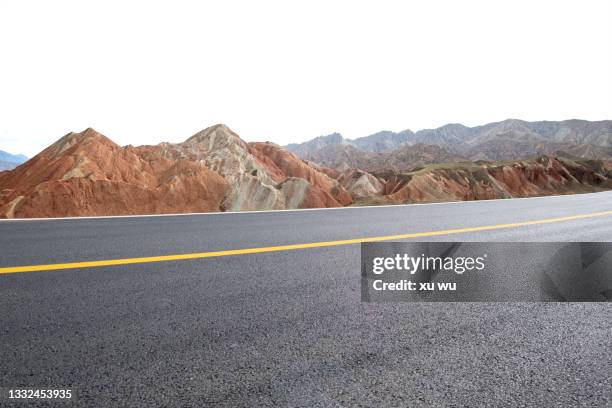 colorful danxia beside the highway in gansu - national cycling road championships stock pictures, royalty-free photos & images