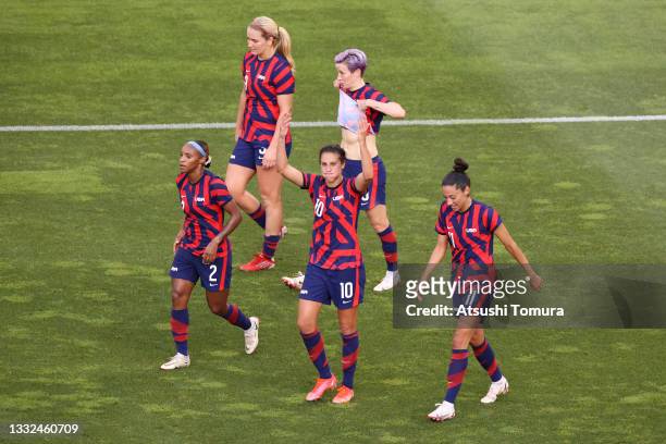 Carli Lloyd of Team United States celebrates with Crystal Dunn and Christen Press after scoring their side's third goal during the Women's Bronze...