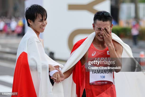 Koki Ikeda and Toshikazu Yamanishi of Team Japan celebrate after finishing second and third in the Men's 20km Race Walk on day thirteen of the Tokyo...