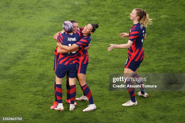 Carli Lloyd of Team United States celebrates with Megan Rapinoe and Christen Press after scoring their side's fourth goal during the Women's Bronze...