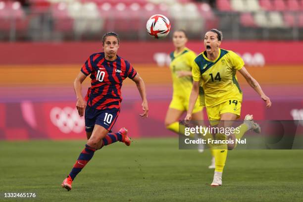 Carli Lloyd of Team United States breaks past Alanna Kennedy of Team Australia before going on to score their side's fourth goal during the Women's...