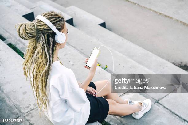 young woman with dreadlocks in the city stairs. - dreadlocks back stock pictures, royalty-free photos & images