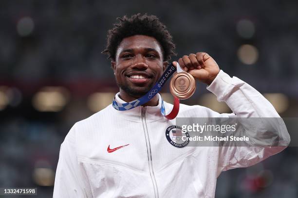 Bronze medalist Noah Lyles of Team United States holds up his medal on the podium during the medal ceremony for the Men's 200 metres on day thirteen...