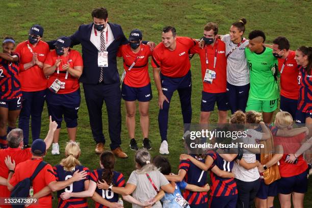 Vlatko Andonovski, Head Coach of Team United States speaks with his players as they celebrate following victory in the Women's Bronze Medal match...