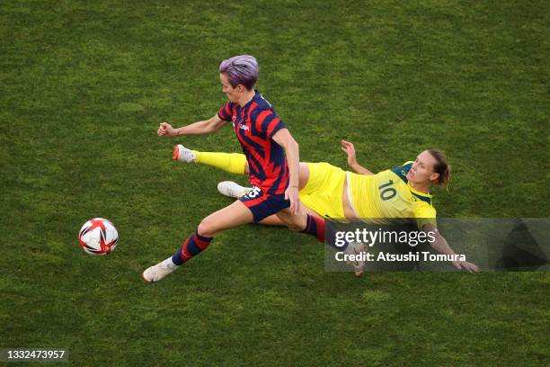 Megan Rapinoe of Team United States is challenged by Emily Van Egmond of Team Australia during the Women's Bronze Medal match between United States...