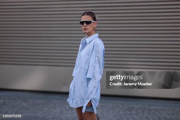 Alessa Winter wearing Balenciaga oversized blue stripe flanell and Prada white shades on August 03, 2021 in Berlin, Germany.