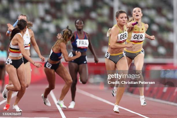 Laura Muller hands the batton off to Ruth Sophia Spelmeyer-Preus of Team Germany competes in the Women's 4 x 400m Relay heats on day thirteen of the...