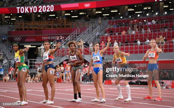 The athletes wait to receive the baton in the Women's 4 x 400m Relay heats on day thirteen of the Tokyo 2020 Olympic Games at Olympic Stadium on...