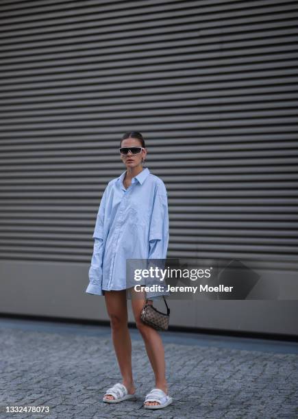 Alessa Winter wearing Balenciaga oversized blue stripe flanell, Prada white shades, Gucci mini vintage bag and Suicoke white sandals on August 03,...