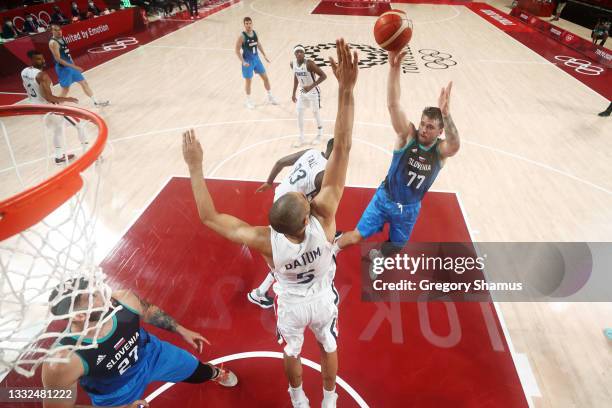 Luka Doncic of Team Slovenia shoots over Nicolas Batum of Team France during the second half of a Men's Basketball semi-finals game on day thirteen...