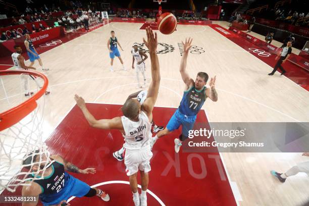 Luka Doncic of Team Slovenia shoots over Nicolas Batum of Team France during the second half of a Men's Basketball semi-finals game on day thirteen...