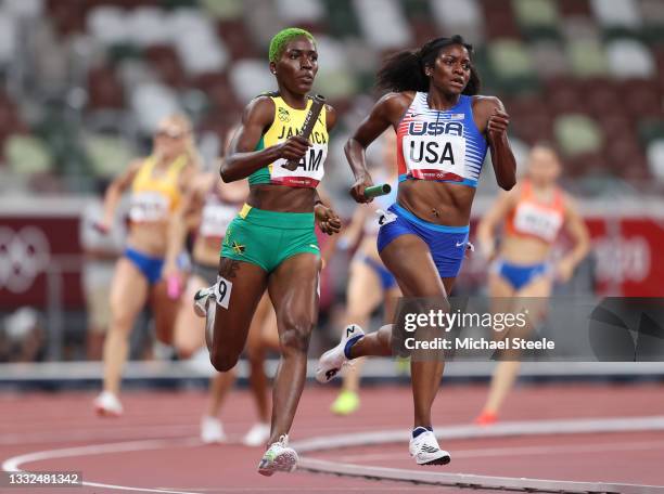 Kendall Ellis of Team United States and Janieve Russell of Team Jamaica compete in the Women's 4 x 400m Relay heats on day thirteen of the Tokyo 2020...