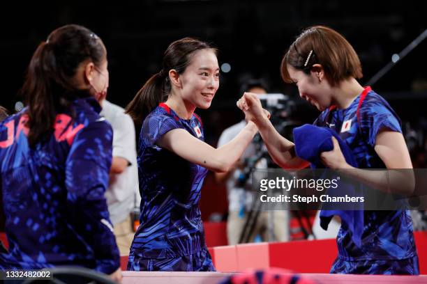 Ito Mima of Team Japan looks on as her teammates Ishikawa Kasumi and Hirano Miu fist bump before their Women's Team Gold Medal table tennis match on...