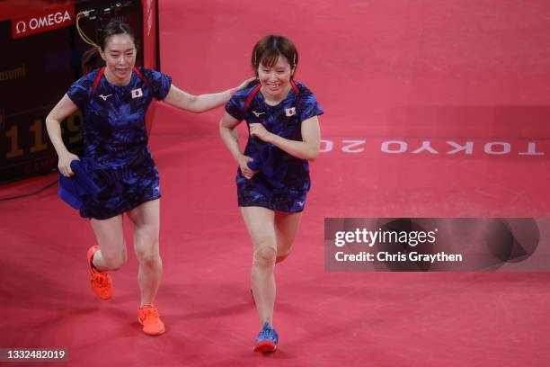 Ishikawa Kasumi and Hirano Miu react during their Women's Team Gold Medal table tennis match on day thirteen of the Tokyo 2020 Olympic Games at Tokyo...