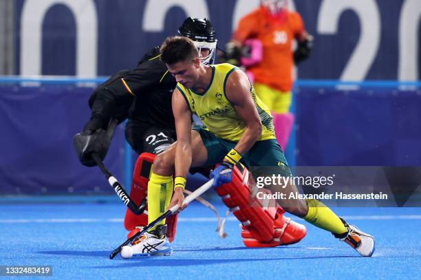 Tim Brand of Team Australia scores their team's third penalty in the penalty shootout past Vincent Vanasch of Team Belgium during the Men's Gold...