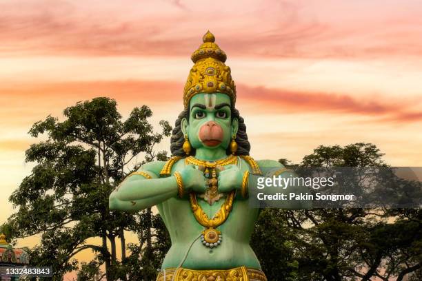 statue of hanuman at batu caves with sunset sky background, kuala lumpur - batu caves stock pictures, royalty-free photos & images