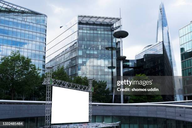 blank advertising screen against modern office buildings - billboard poster stock pictures, royalty-free photos & images