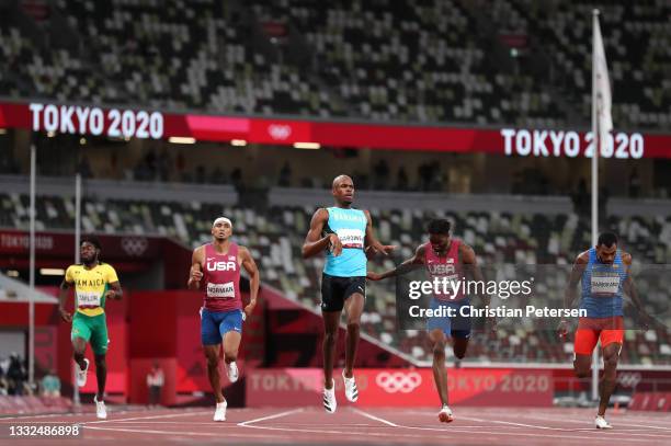 Steven Gardiner of Team Bahamas crosses the finish line to win the gold medal in the Men's 400m Final on day thirteen of the Tokyo 2020 Olympic Games...