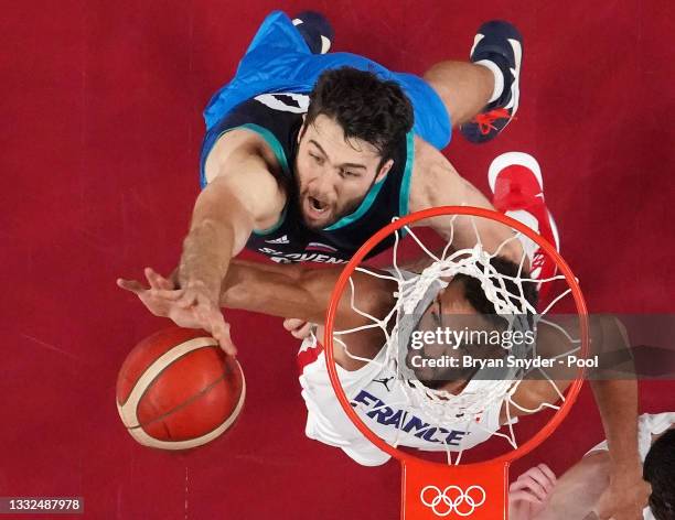 Rudy Gobert of Team France and Mike Tobey of Team Slovenia go up for a rebound during the first half of a Men's Basketball semi-finals game on day...