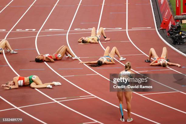 The athletes lay on the track after Women's Heptathlon 800m heats on day thirteen of the Tokyo 2020 Olympic Games at Olympic Stadium on August 05,...