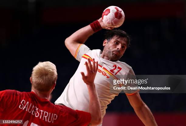 Antonio Garcia Robledo of Team Spain shoots at goal while Magnus Saugstrup of Team Denmark looks on during the Men's Semifinal handball match between...