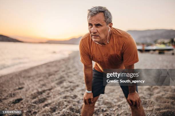 senior relaxing after exercising - senior woman running stock pictures, royalty-free photos & images