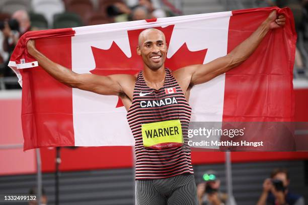 Damian Warner of Team Canada celebrates after winning the gold meldal in the Men's Decathlon on day thirteen of the Tokyo 2020 Olympic Games at...