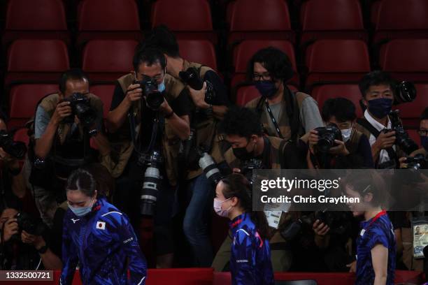 Photographers surround Ishikawa Kasumi of Team Japan and her teammates Ito Mima and Hirano Miu as they leave after losing their Women's Team Gold...