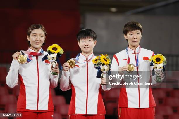 Team China players Chen Meng, Sun Yingsha , and Wang Manyu pose with their medals during the medal ceremony after winning their Women's Team Gold...