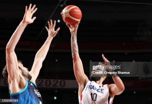 Evan Fournier of Team France goes up for a shot against Mike Tobey of Team Slovenia during the second half of a Men's Basketball semifinals game on...