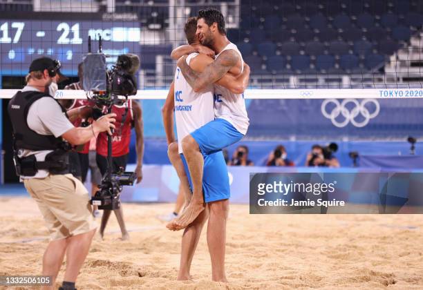 Viacheslav Krasilnikov and Oleg Stoyanovskiy of Team ROC react after defeating Team Qatar during the Men's Semifinal beach volleyball on day thirteen...