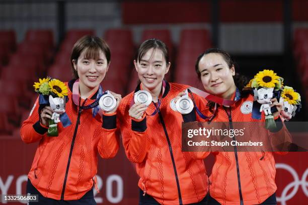 Team Japan players Hirano Miu, Ishikawa Kasumi and Ito Mima pose with their medals during the medal ceremony for the Women's Team table tennis on day...