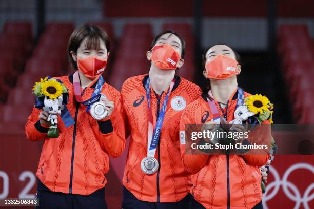 Team Japan players Hirano Miu, Ishikawa Kasumi and Ito Mima pose with their medals during the medal ceremony for the Women's Team table tennis on day...