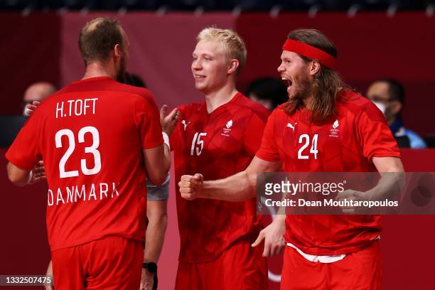 Henrik Toft Hansen, Magnus Saugstrup and Mikkel Hansen of Team Denmark celebrate winning after the final whistle of the Men's Semifinal handball...