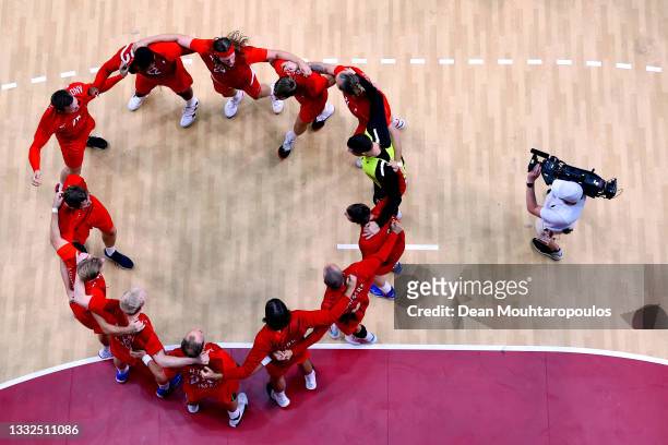 Team Denmark celebrate after winning the Men's Semifinal handball match between Spain and Denmark on day thirteen of the Tokyo 2020 Olympic Games at...