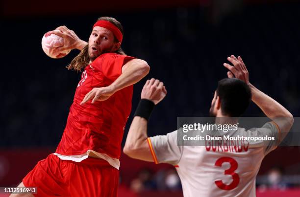 Mikkel Hansen of Team Denmark shoots at goal as Eduardo Gurbindo Martinez of Team Spain defends during the Men's Semifinal handball match between...