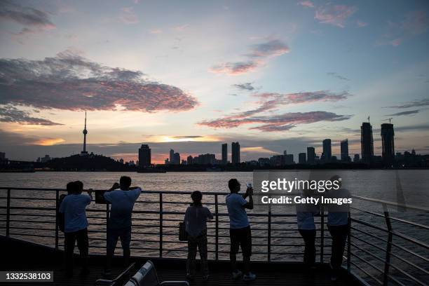 Residents watch the scenery on the deck while a ferry crossing the Yangtze River on August 5, 2021 in Wuhan, Hubei Province, China.The government...