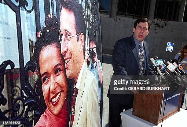 Daniel Pearl's childhood friend Daniel Gill speaks to reporters next to a 1999 wedding photo of Pearl and his wife Mariane at Skirball center in Los...