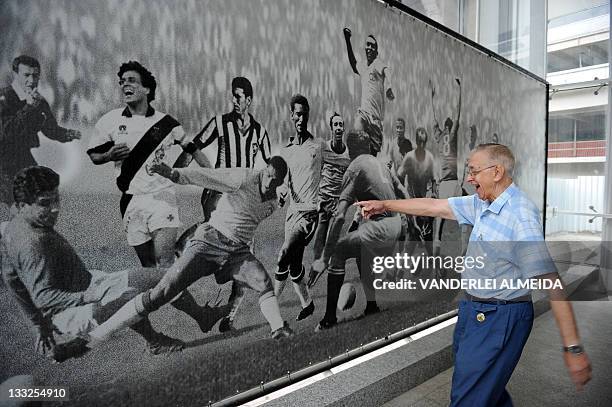 By Louis Genot Brazilian 77-year-old football fan Francisco Camoes de Menezes, points at one of his idols, Garrincha, , at the Mario Filho Stadium,...