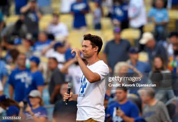 Drew Seeley, a Canadian-American actor, singer and dancer, sings the National anthem during the baseball game between the Los Angeles Dodgers and...