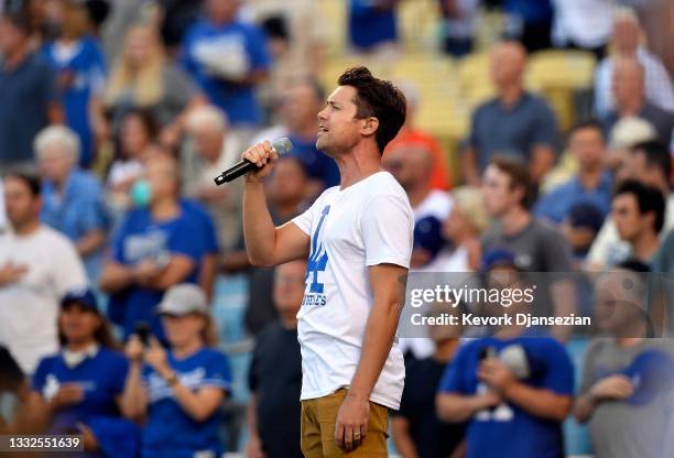 Drew Seeley, a Canadian-American actor, singer and dancer, sings the National anthem during the baseball game between the Los Angeles Dodgers and...