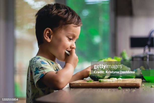 little boy eating vegetables - ecuadorian ethnicity stock pictures, royalty-free photos & images