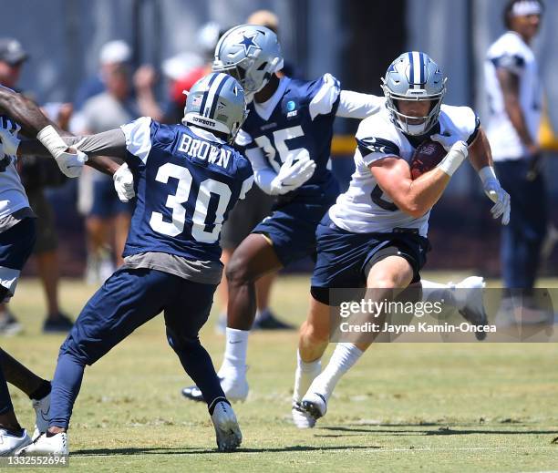 Tight end Blake Jarwin runs past cornerback Anthony Brown of the Dallas Cowboys during training camp at River Ridge Complex on August 3, 2021 in...