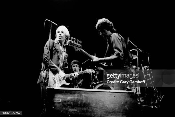 The members of American Rock and Pop group Tom Petty and the Heartbreakers perform onstage during the 'Damn the Torpedoes' tour at the Capitol...