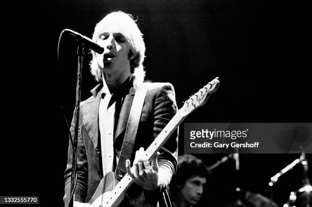 American Rock and Pop musician Tom Petty plays guitar as he perfroms, with his band the Heartbreakers, during the 'Damn the Torpedoes' tour at the...
