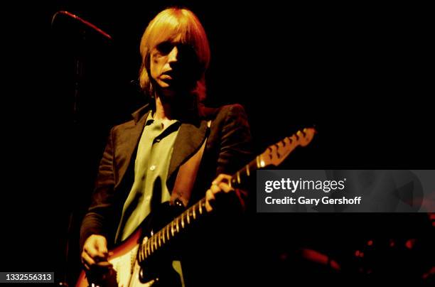 American Rock and Pop musician Tom Petty plays guitar as he perfroms, with his band the Heartbreakers, during the 'Damn the Torpedoes' tour at the...