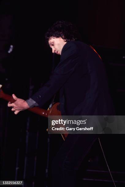 American Rock and Pop musician Mike Campbell of the group Tom Petty and the Heartbreakers, plays guitar as he performs onstage during the 'Damn the...