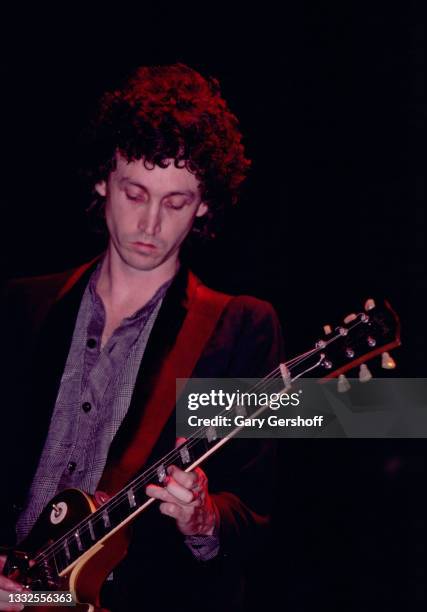 American Rock and Pop musician Mike Campbell of the group Tom Petty and the Heartbreakers, plays guitar as he performs onstage during the 'Damn the...