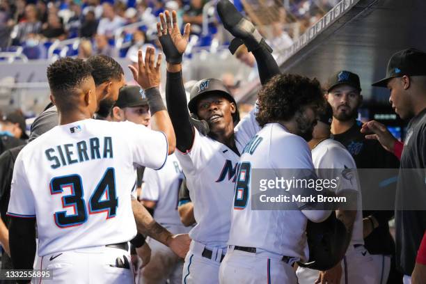Jazz Chisholm Jr. #2 of the Miami Marlins celebrates with teammates in the dugout after scoring a run in the eighth inning against the New York Mets...